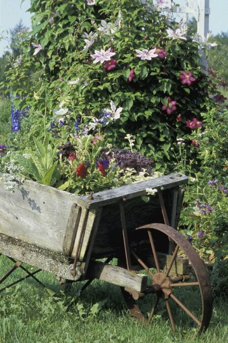 EXTERIOR DECORATION:  A sculpture or even just an old wheelbarrow can provide a focus for the eye.
