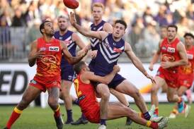 Players struggled to keep their feet when Fremantle hosted Gold Coast at Optus Stadium on June 23. (Richard Wainwright/AAP PHOTOS)